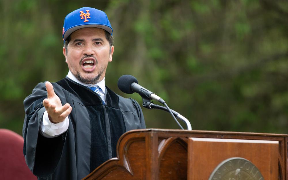 John Leguizamo at a podium during Commencement