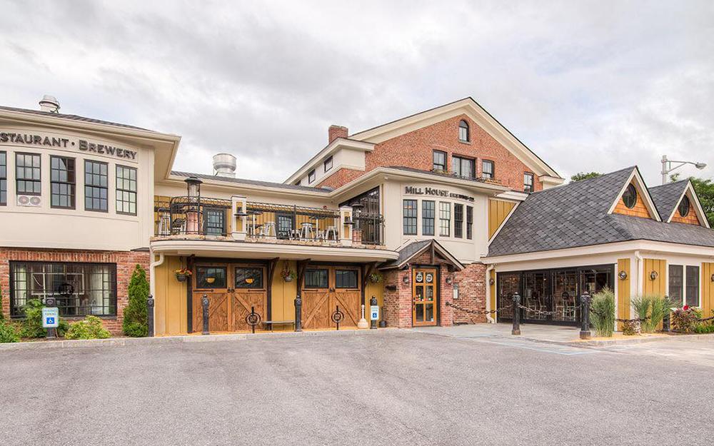 Exterior of Mill House Brewing Company - Red brick, tan and yellow multi room, three floor building