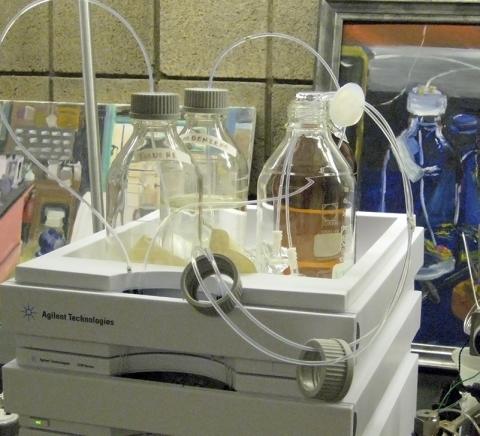chemistry-instrument4 glass bottles in a tray with hoses coming out of them.