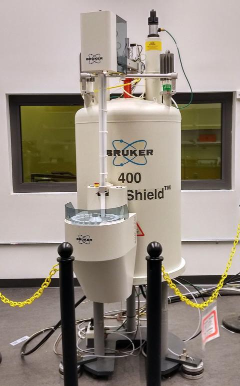 chemistry-nmr-instrument3 large upright pressurized tank with gauges and hoses attached