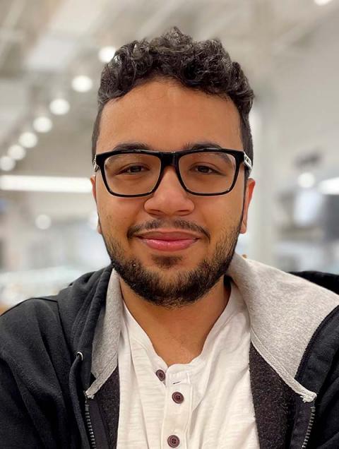 A photo of a young man with glasses and a beard.