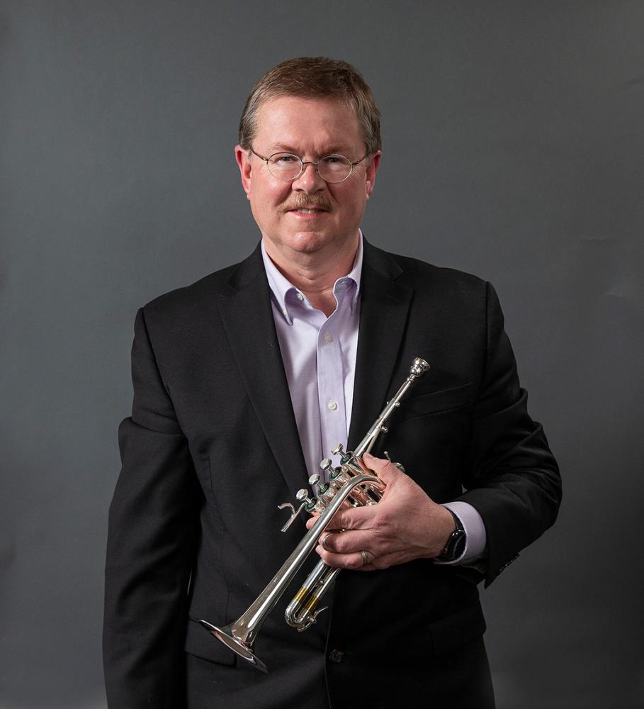 Portrait of James Osborn holding a trumpet