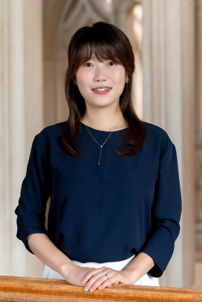 Portrait of a person with the Vassar Library in the background.