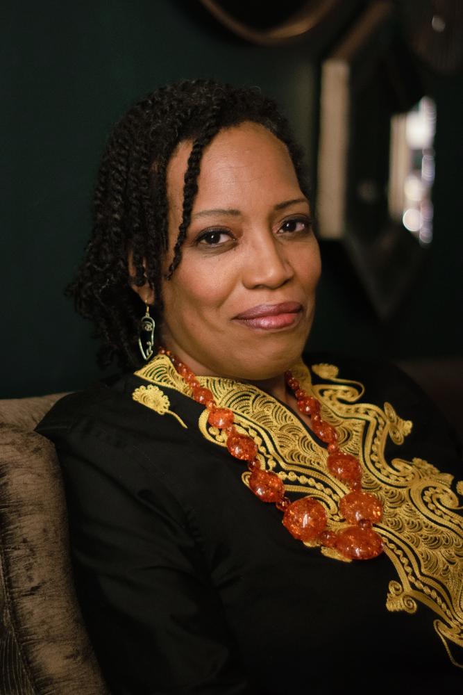 Portrait of Shona Tucker. A person sitting in a chair looking at the camera.