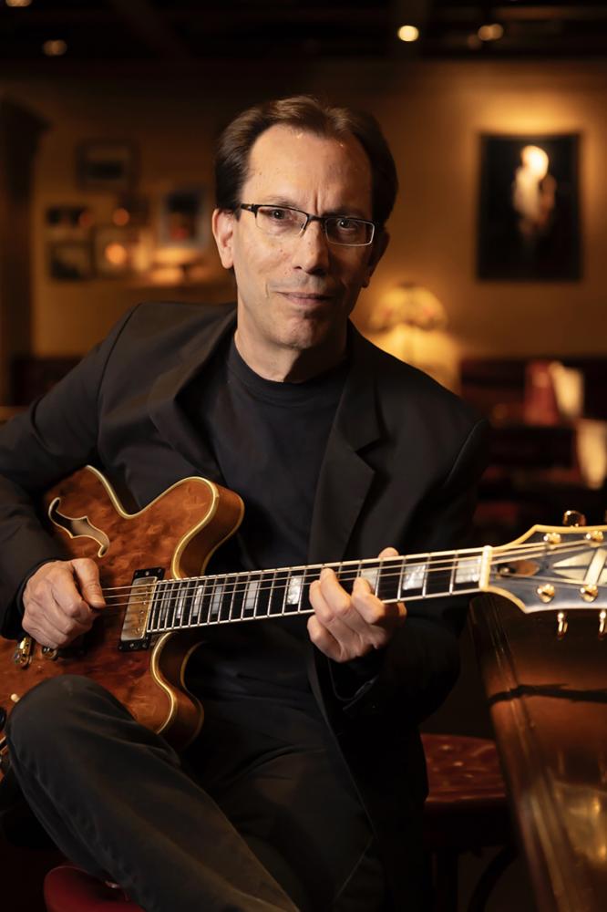 Profile picture of the subject holding their guitar.