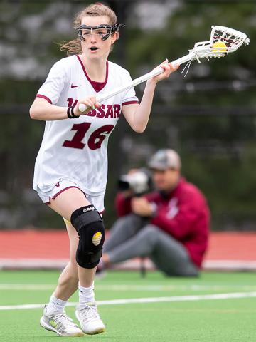 action shot of lacrosse player Kateri Sanseviro ’23