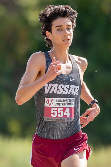 Closeup action shot of Miles Takiguchi running in a race.