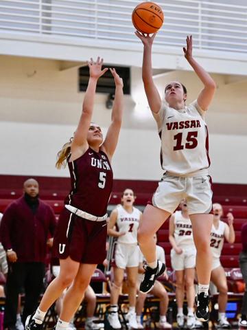 Sierra McDermed ’26 leaps up with the ball while an opponent attempts to block her shot.