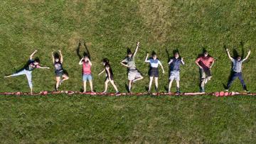 Drone photo with students posing on grass.