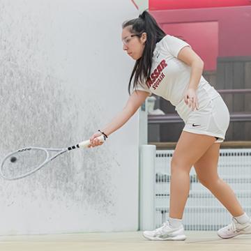 Adriana Ordaya hits the ball with her racket