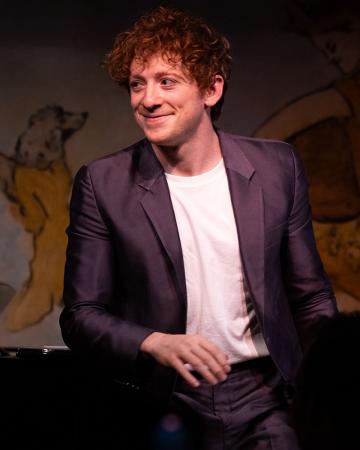 Ethan Slater onstage during a one-man performance of songs.