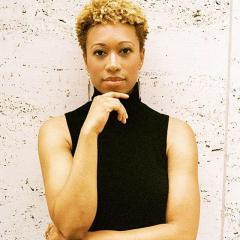 Head and upper body photo of Amy Hall Garner wearing a black sleeveless shirt with a light background.