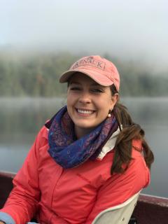 Portrait of a woman in front of a fog covered lake.