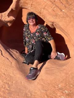 Woman sitting on orange sandstone rocks