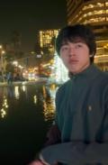 Man standing on a street at night