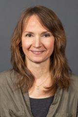 Woman with long golden brown hair smiling