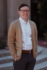 Portrait of person standing outdoors.