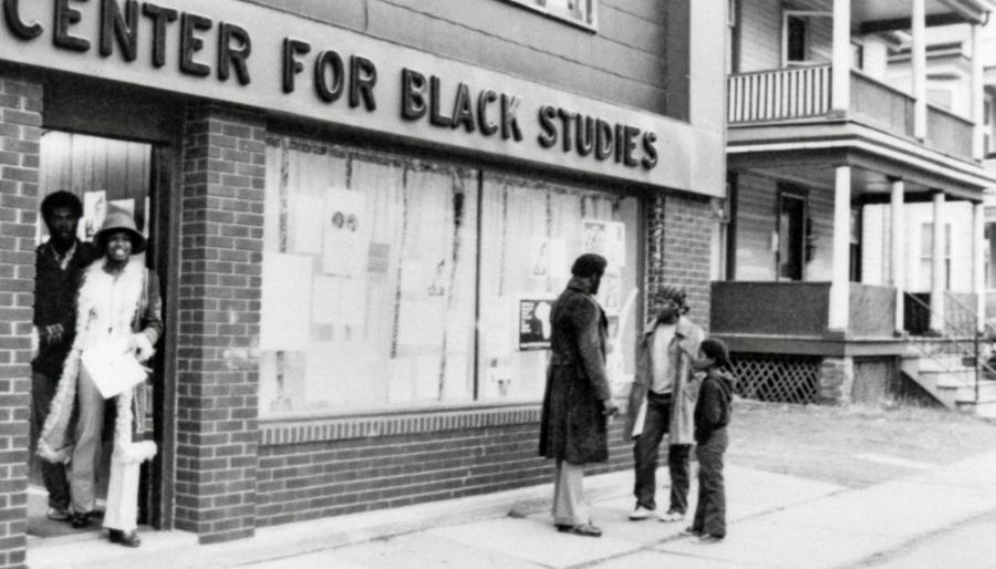 People outside of a building with a sign that reads: Center for Black Studies.