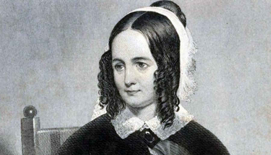 Black-and-white 19th-century portrait of a woman with center-parted dark curls, wearing a lace collar and light head covering, seated against a plain backdrop.