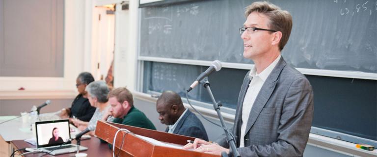 Associate Dean of Religious and Spiritual Life and Contemplative Practice Sam Speers speaking at an early meeting of Vassar Refugee Solidarity and discussion panel with Professor Ismael Rashid (second from right) Professor Maria Höhn (second from left), and Professor Diane Harriford (left). 