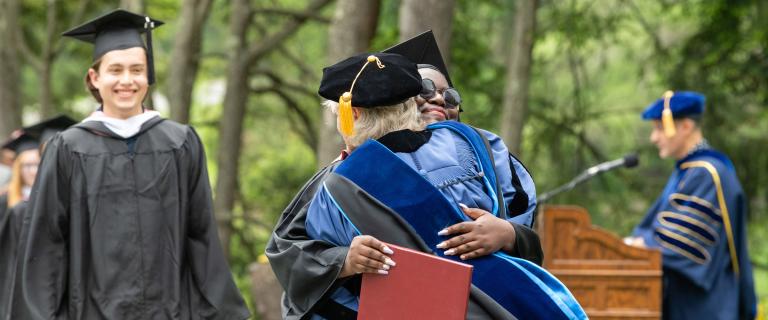 Student receiving diploma at Commencement 2022