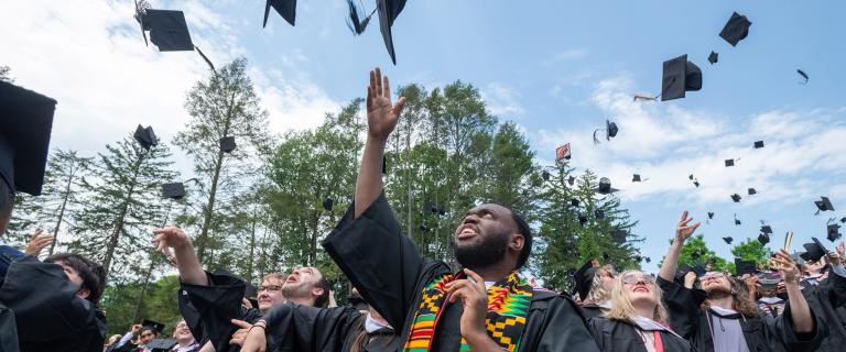 Students throwing their Caps at Commencement 2022