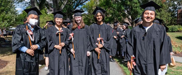 Students wearing caps and gowns posing for photo at Vassar College Convocation.