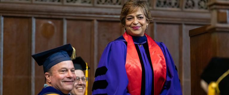 Mita Choudhury wearing blue gown with red stole at Vassar College Convocation.