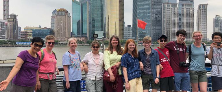 Group photo of Asian Studies trip with city skyline in the background