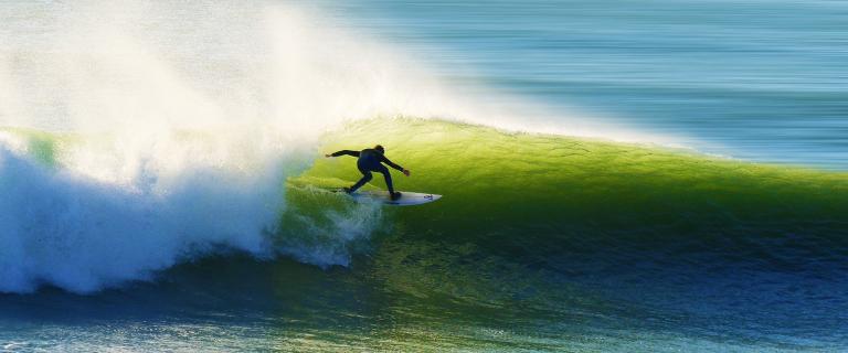 Surfer on a wave shortly after pandemic lockdown, Les Sables-d'Olonne, France