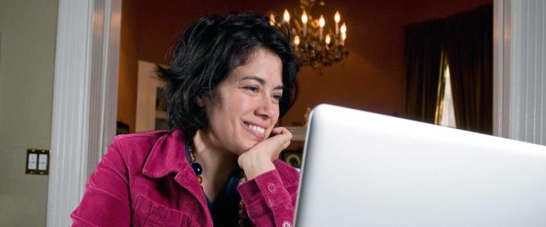 Caterina Fake sitting in front of a laptop
