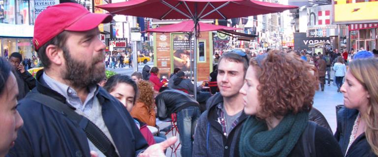 Students and professor speaking outside in Times Square, NYC