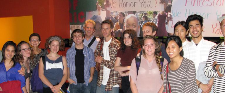 A large group of students lined up and smiling for the camera