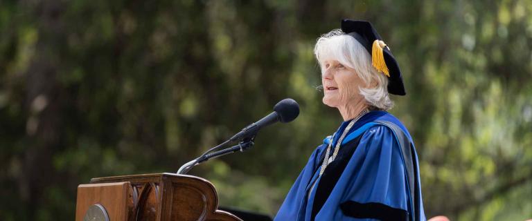 Commencement speaker speaking behind a podium and microphone