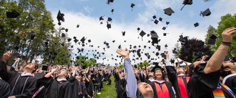 Graduates throwing their caps in celebration