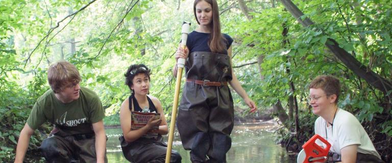 Students and professors Marshall Pregnall and Kirsten Menking taking samples to measure stream quality in Casperkill Creek.