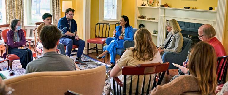 A group of people in a room in a discussion.