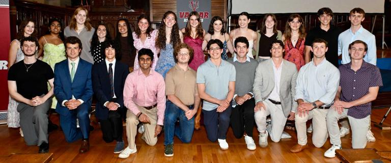 Two rows of people smiling for a photo.