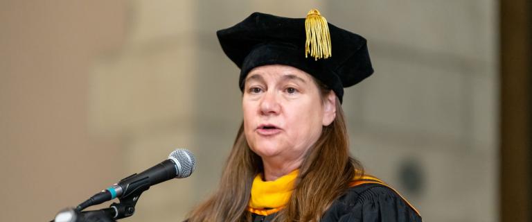 Convocation speaker behind the mic.