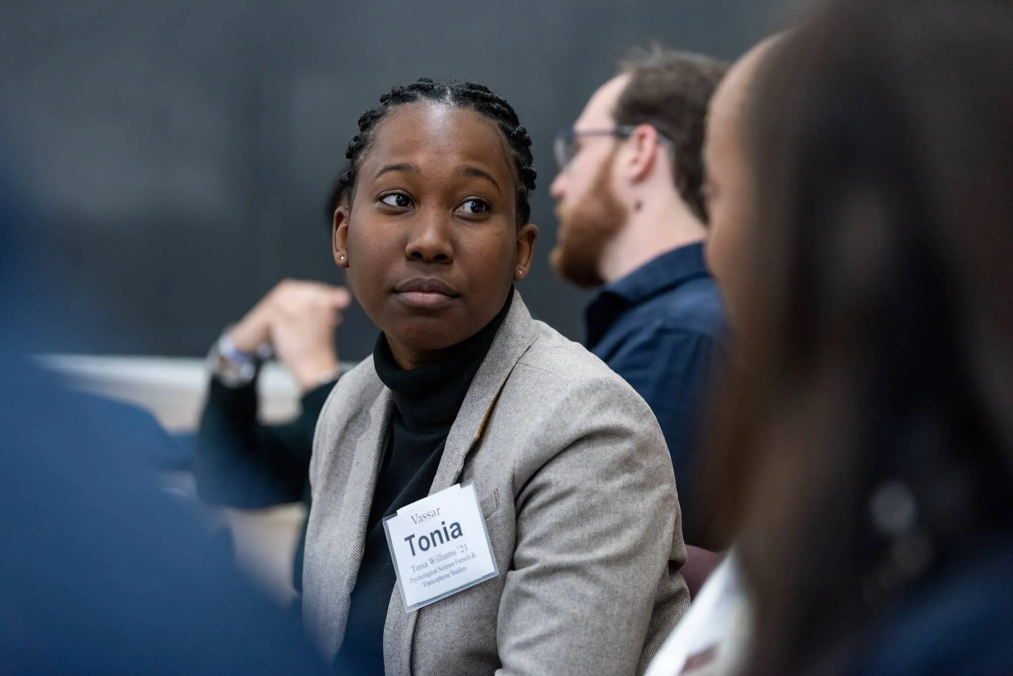 Student with a name tag in a suit. 