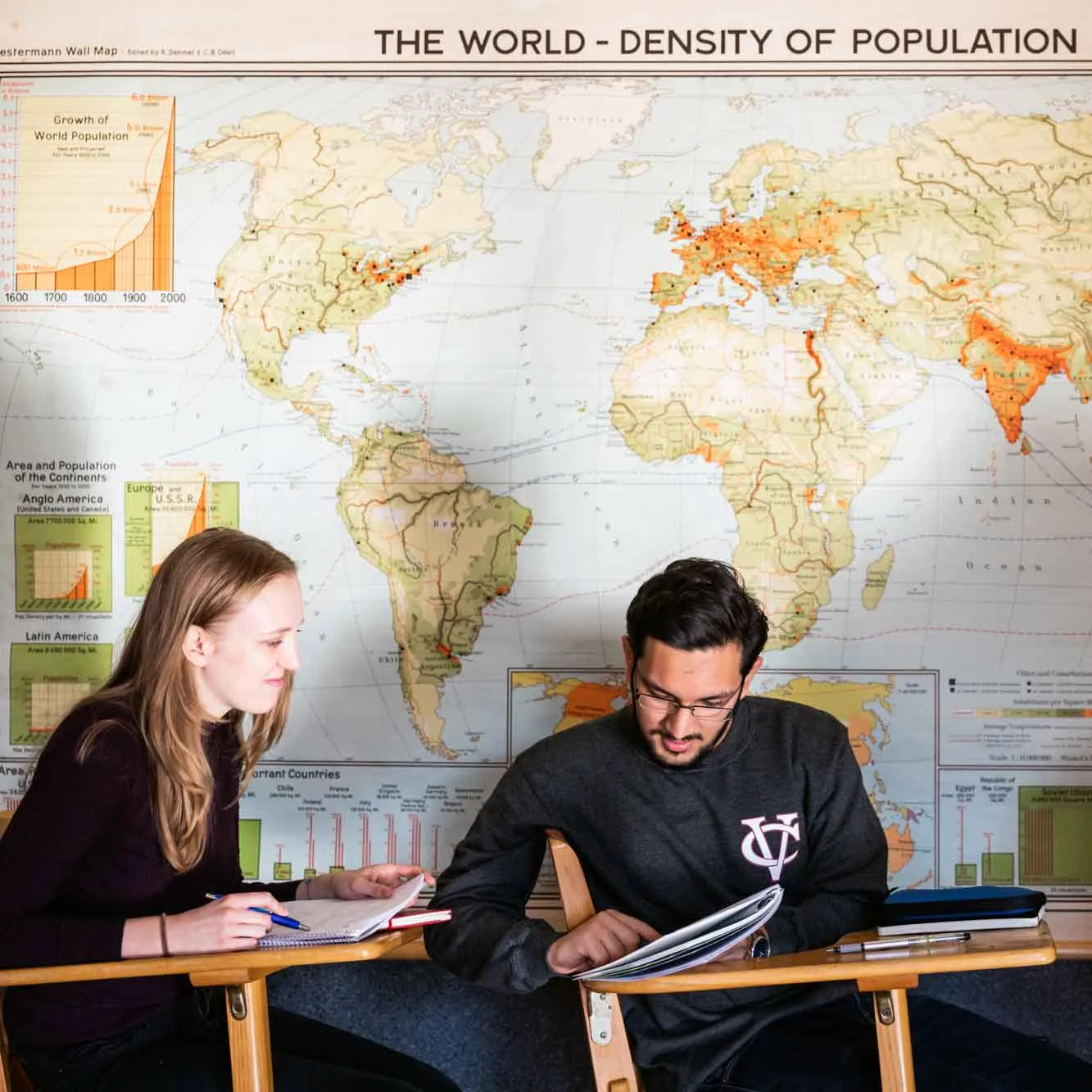 Students studying with wall map behind them