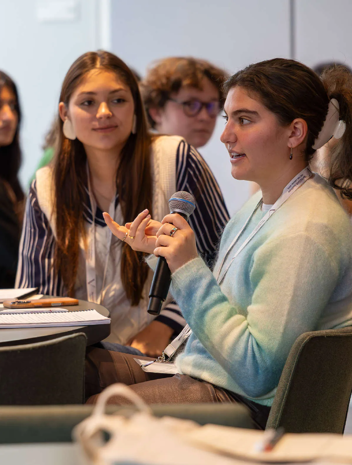 A group of people listen to one person speaking.