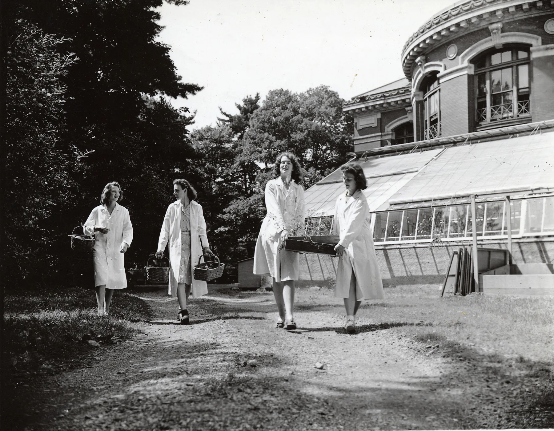 Eleanor Conservatory with students carrying out supplies.
