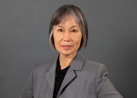 Anne Parries wearing a black shirt and grey jacket