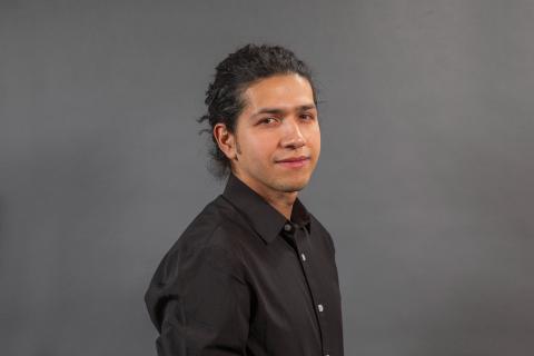 Man in black dress shirt -  Pictured: Carlos Alvarado