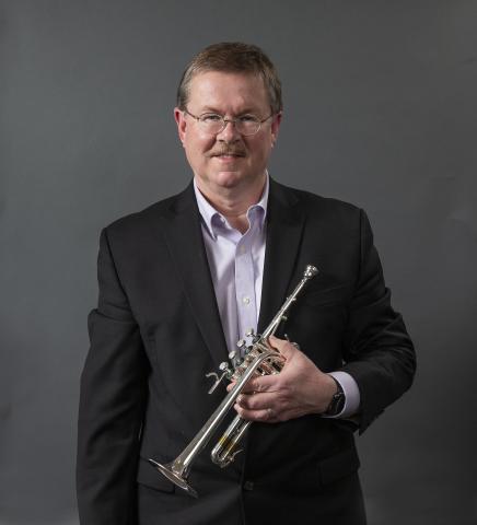 Portrait of James Osborn holding a trumpet