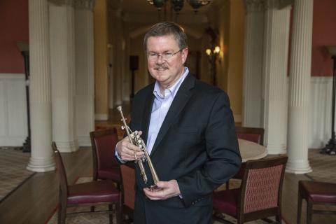 Portrait of James Osborn holding a trumpet