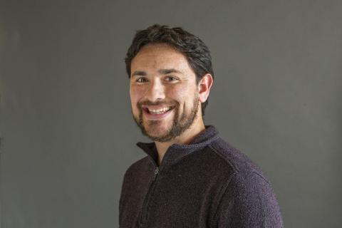 Man with black hair and a beard smiling - Pictured: Payton Small 