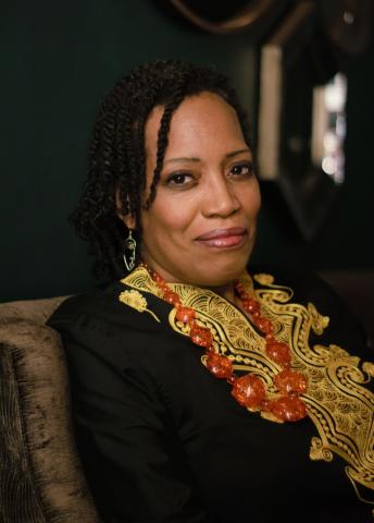 Portrait of Shona Tucker. A person sitting in a chair looking at the camera.