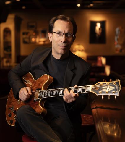 Profile picture of the subject holding their guitar.